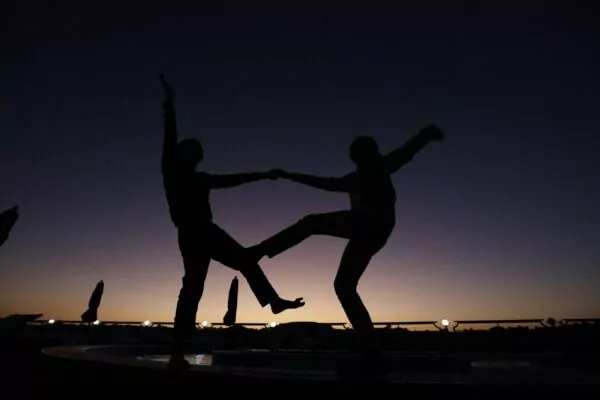 a couple of people standing on top of a fountain