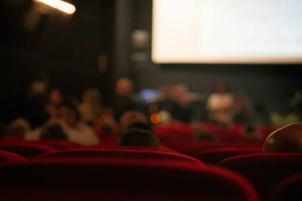 A blurry photo of people in a movie theater